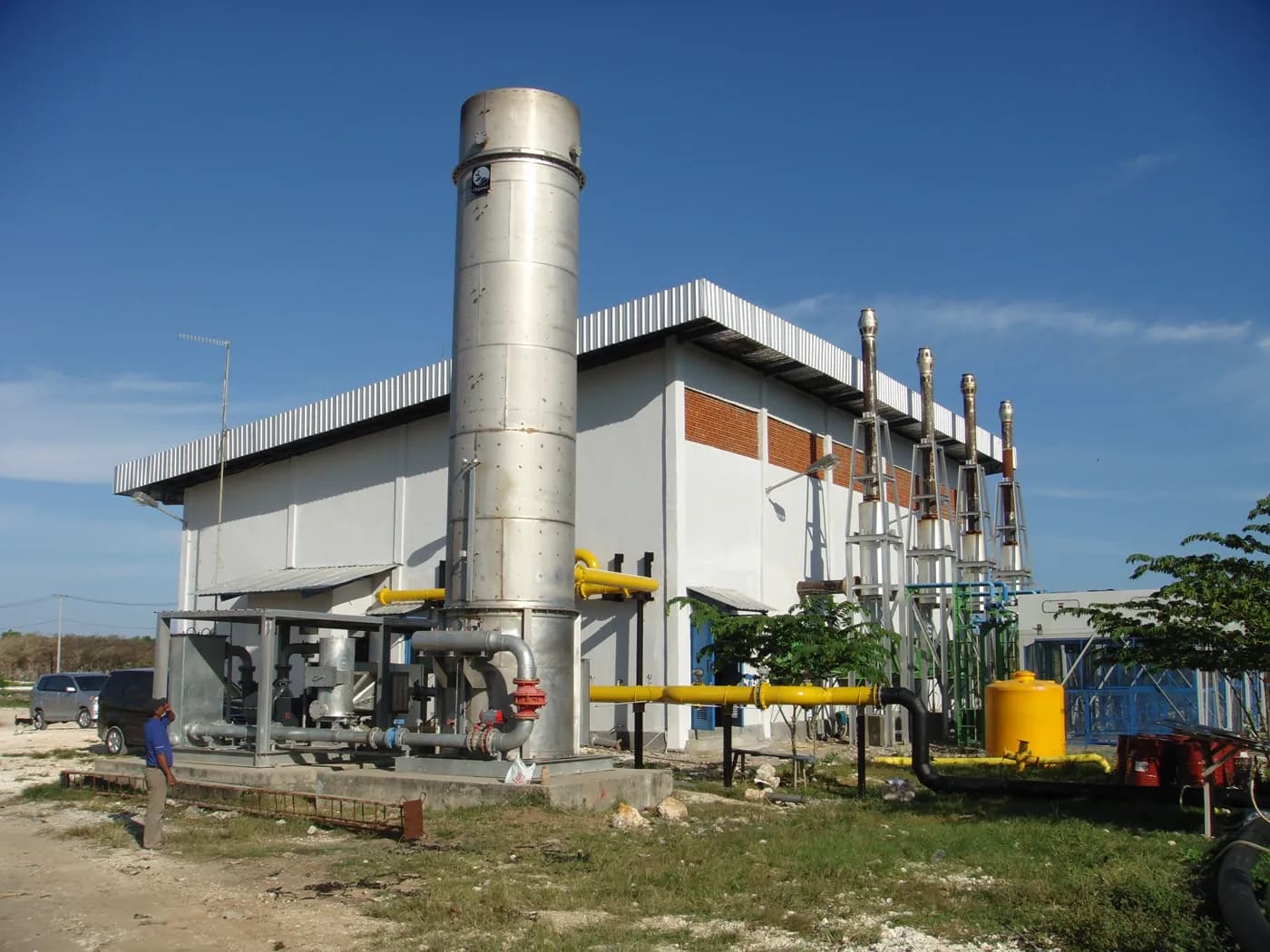 An Organics plant on site, with a tall stainless steel stack and gas pipework